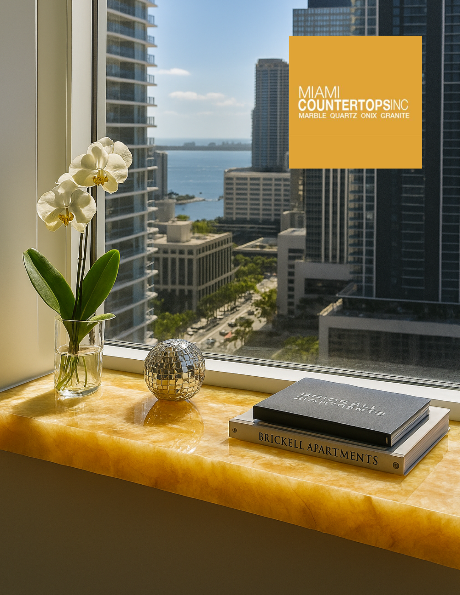 Polished yellow stone windowsill with decorative accents and panoramic Miami skyline view from a luxury residence.